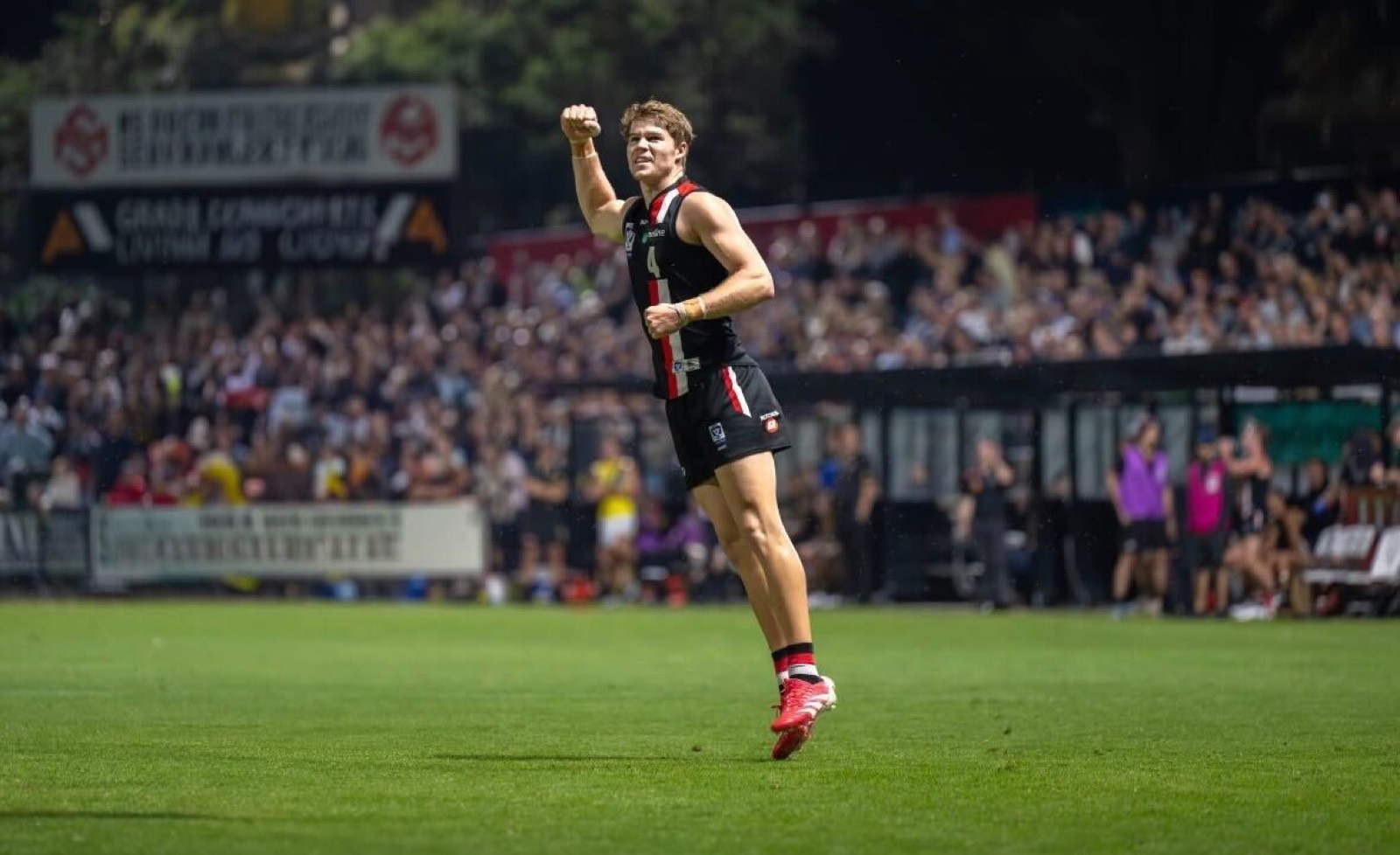 Frankston player celebrating a goal in front of the home crowd